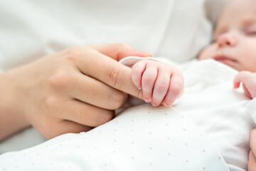 Tiny fingers cling to maternal assurance. Concept of the deep trust newborns instinctively feel