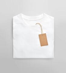 White folded t-shirt with price tag label.