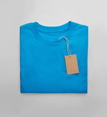 Blue folded t-shirt with price tag label.