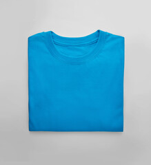 Blue folded t-shirt with on white background - obrazy, fototapety, plakaty