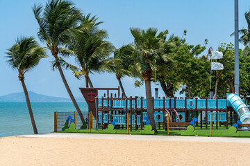 A colorful playground for small children in a city park on the seashore in bright sunny weather. Family holiday in nature.