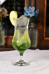 apple juice alcoholic drink with green apple and pieces of natural fruit tropical refreshing drink