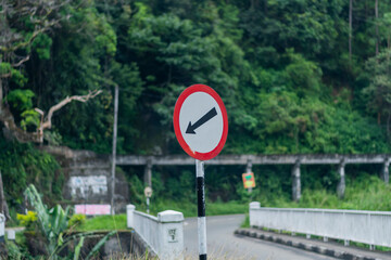 road sign on the side of a small bridge