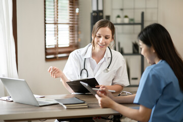 female doctor consulting with a female nurse at the clinic at the hospital