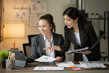 Group of asian business people working, discussing new projects together, having fun at the office.