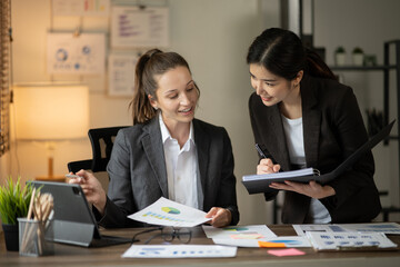 Group of asian business people working, discussing new projects together, having fun at the office.