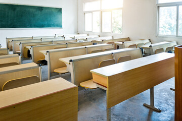 Empty classroom with chairs, desks and chalkboard