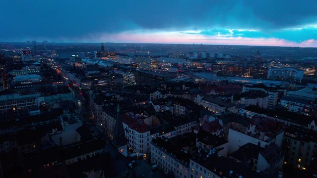 Drone aerial shot of Stockholm skylin, Sweden on a cloudy evening with sunset coming through.