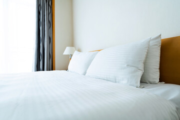 White bed sheet and pillows in hotel room