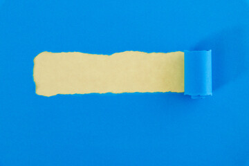 Blue torn paper on yellow background