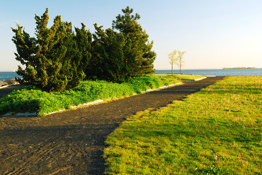 A paved path leads to the sea at Sherwood Island State Park, Connecticut