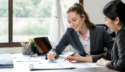 Working together on project. Two young business colleagues working on computer