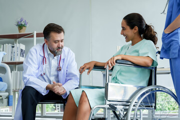 Male doctor, Caucasian orthopedic specialist Introducing a Hispanic female patient in a wheelchair After recovering from an arm injury To prepare for physical therapy with an expert physical therapist