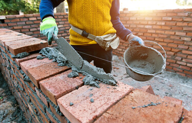 Close up of bricklayer building walls