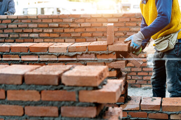 Close up of bricklayer building walls