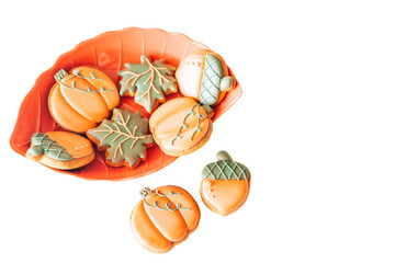 Gingerbread cookies in the shape of a pumpkin, acorn and maple leaf with multi-colored glaze in an...