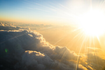 view from the airplane on orange sunset clouds