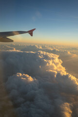 view from the airplane on orange sunset clouds