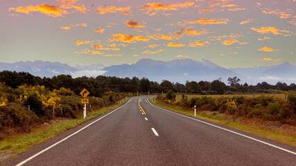 The Road trip view of  travel with mountain view of autumn scene and  foggy in the morning with sunrise sky scene at fiordland national park