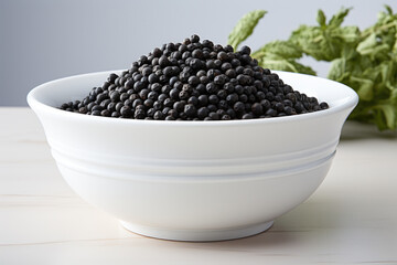 White bowl filled with black beans, perfect for food-related projects or healthy eating concepts.