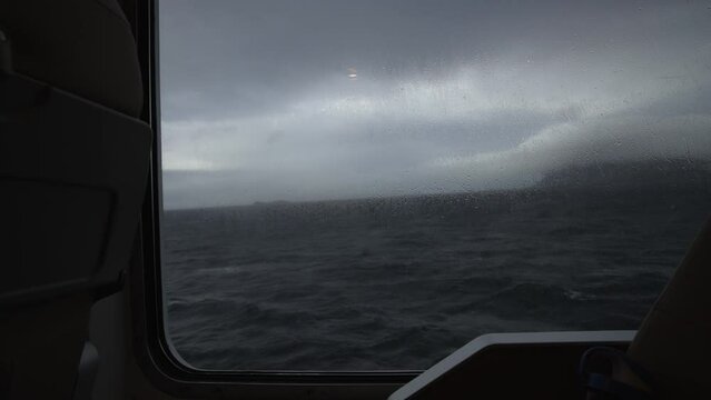 View of the sea from the porthole of the ship. dark mood