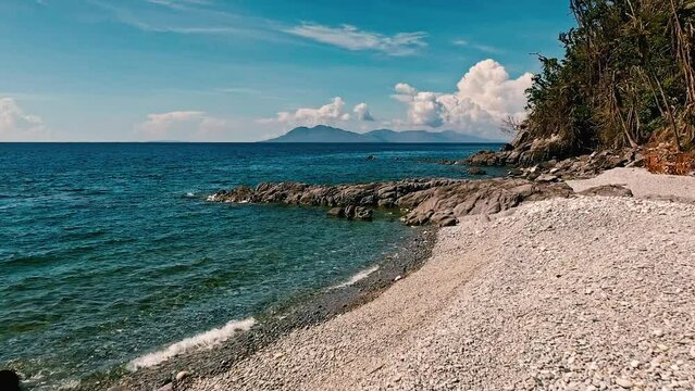 Looc Beach Over a Beach of Shingles on a Beautiful Summer's Day in the Philippines with an Aerial Drone. 