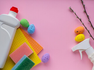 Happy Easter and cleaning concept. Detergent with Easter decoration on pink background with copy...