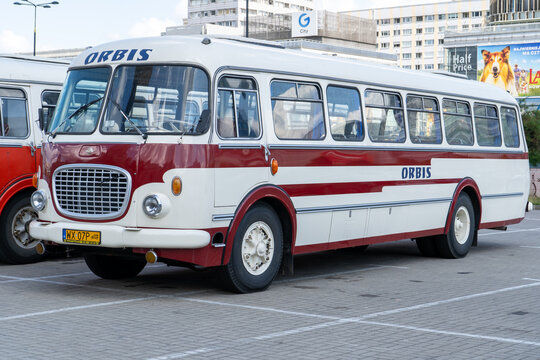 The old red and blue Skoda bus. Czechoslovakian Skoda RTO 706 Karosa model. Tourist buses vintage model. The street of the old city is a tourist attraction. Poland, Warsaw - July 27, 2023.