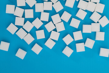 Sugar cubes on blue background