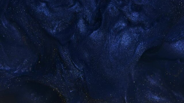 Abstract shiny background video with glitters in motion. Footage with flickering liquid particles. Creating an abstract backdrop with liquid overflowing inks and sparkling shimmers.