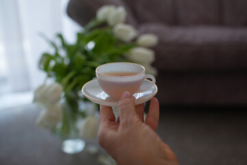 Close-up of middle-aged woman hand hold the cup of tea