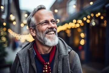 Portrait of a smiling senior man with gray beard and glasses in the city.