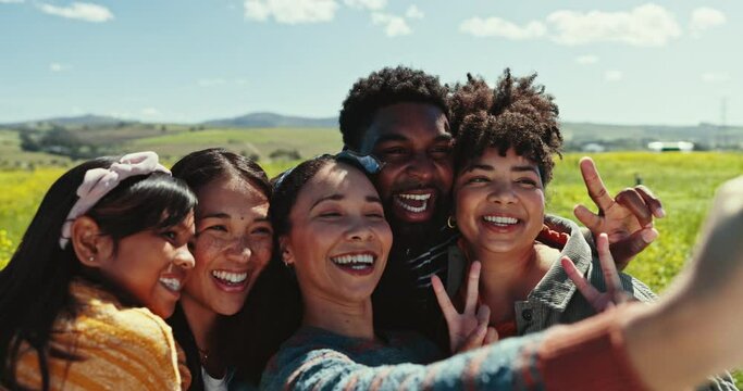 Selfie, friends and peace sign with a group of young people outdoor in nature together for freedom. Emoji, smile or love with men and women posing for a profile picture while in the countryside