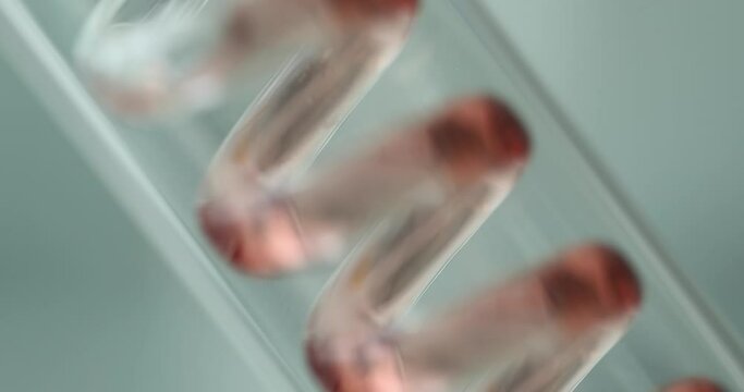 Red liquid flows in glass tube in futuristic data laboratory. Medical science and laboratory of future