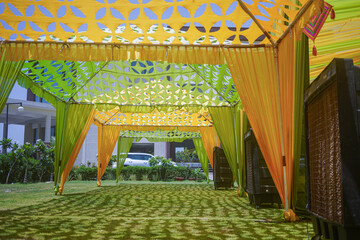 Indian wedding ceremony :stage decoration with green theme 
