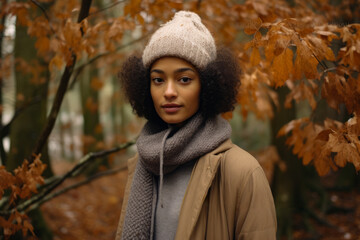 Multiethnic woman enjoying autumn in the woods on a snowy day