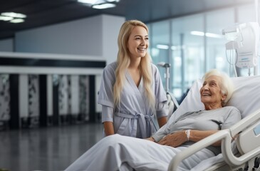 Obraz premium In a touching scene at the hospital, a young sister shows unwavering love and support as she visits an elderly woman lying in a hospital bed, embodying the enduring bond of family and compassion.