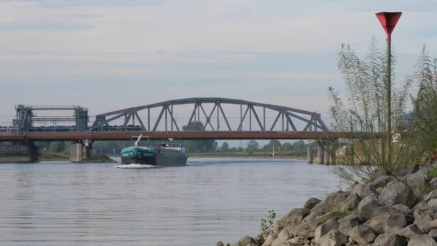 Bridge over the IJssel river in Zutphen in the Netherlands with a yellow train driving over it