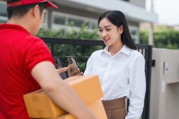 Asian people received product box from male delivery service person, modern e-commerce, home deliveries, convenient shopping experience, trustworthy doorstep service captured in moment.