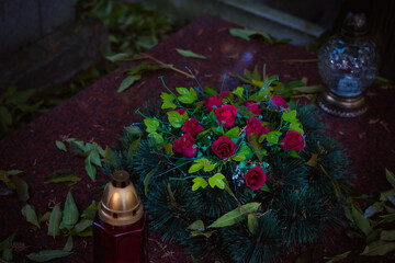 All Saints Day in cemetery in nostalgic autumnal time, floral bouquet