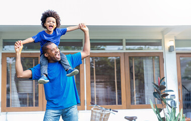 Happy black African American father daughter playing home outdoor. Afro man carry piggyback little...