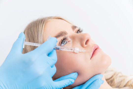 doctor with a syringe injecting patient with botox
