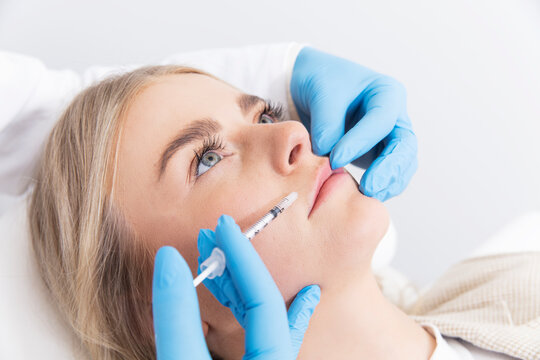 doctor with a syringe injecting patient with botox