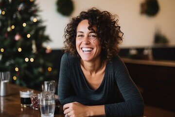 Portrait of happy young woman sitting in cafe at christmas time - Powered by Adobe