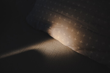 Some sunlight and shadows on bed linen . Crumpled blanket on morning bed , unmade bed. good morning concept