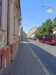 Fototapeta na wymiar A view of the movement of public transport along the clean cobblestones of the old historical part of the city of Chernivtsi.