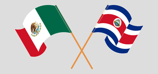 Crossed and waving flags of Mexico and Costa Rica