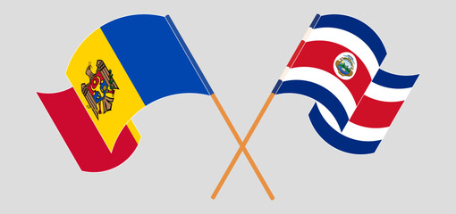Crossed and waving flags of Moldova and Costa Rica