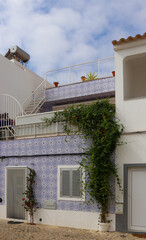 Residential home with traditional house facade decorated with Portuguese azulejo tiles (Algarve,...