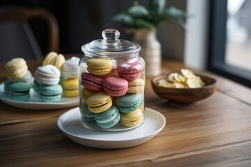Obraz na płótnie Canvas assorted macarons in a clear glass jar on a wooden table